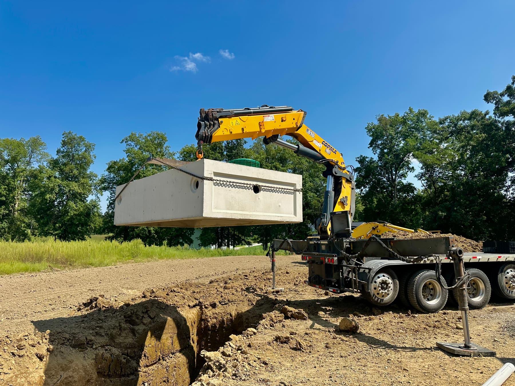 PFL Construction crew installing a concrete septic tank